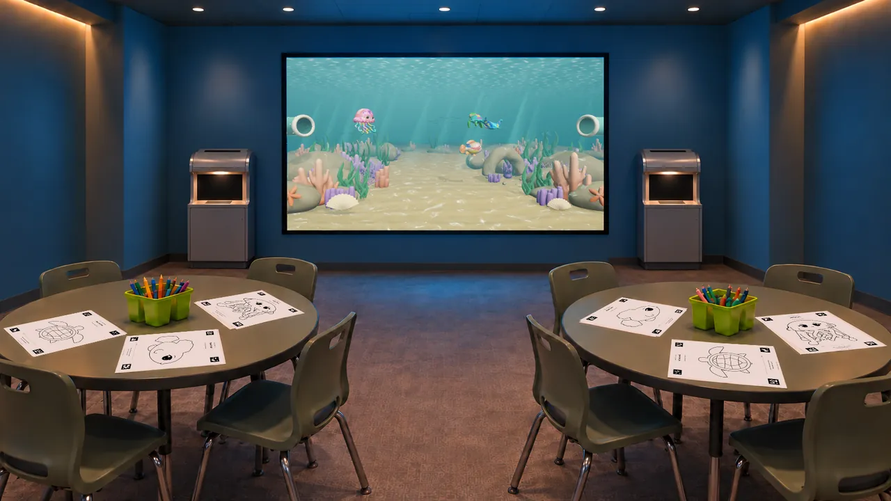 Uncolored marine templates on tables facing the Sketch Bloom reef display and scanning stations.